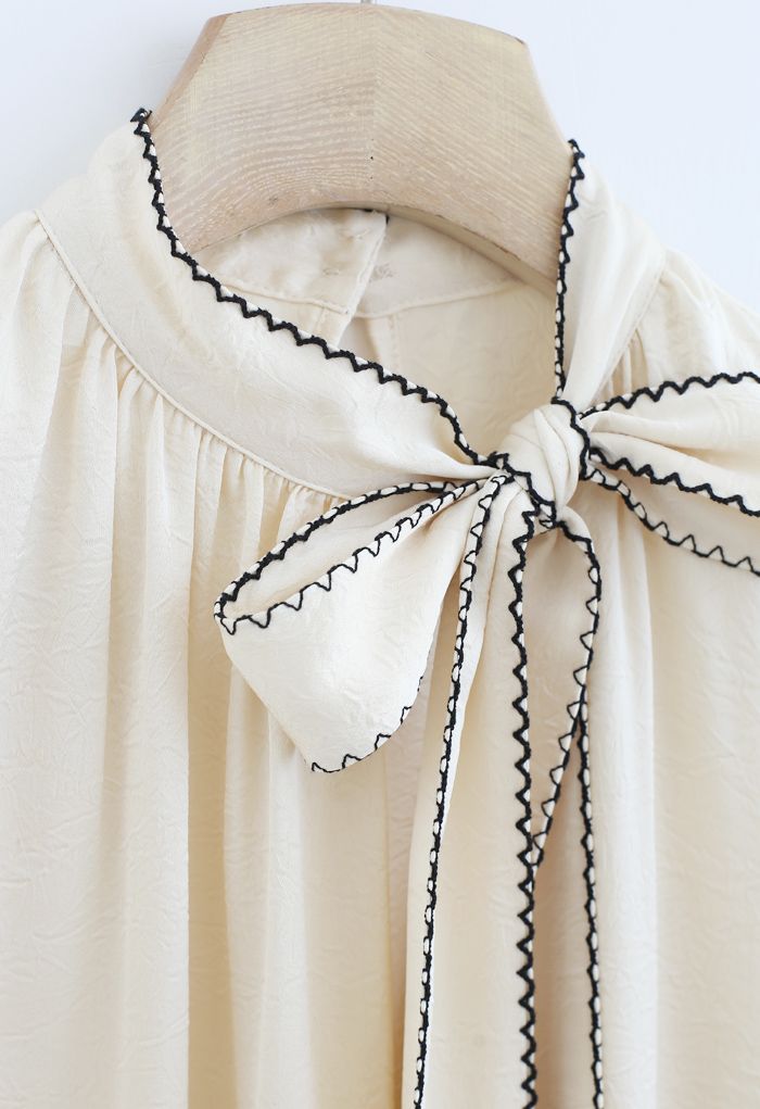 Seamed Edge Bowknot Textured Satin Top in Cream